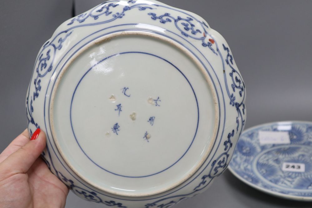 Two Japanese Arita dishes and a Chinese blue and white dish, largest diameter 24cm